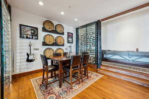 Dining space featuring wood-type flooring and recessed lighting
