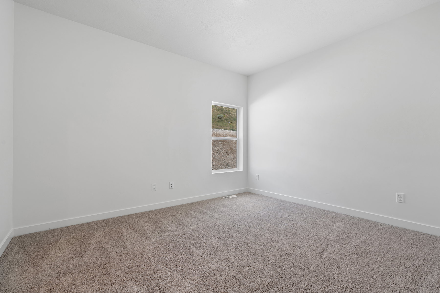 Unfurnished room featuring carpet floors and baseboards
