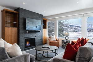 Living room with a stone fireplace