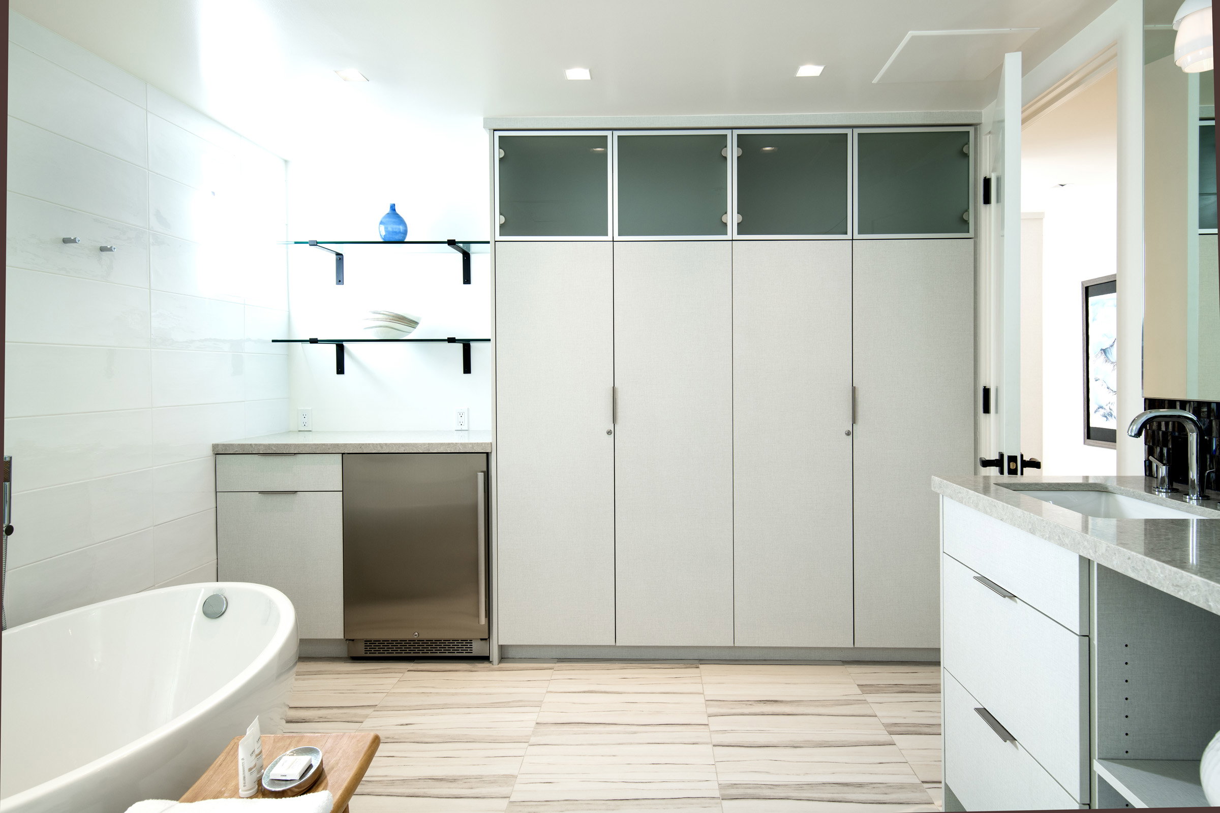 Full bathroom with vanity and a soaking tub