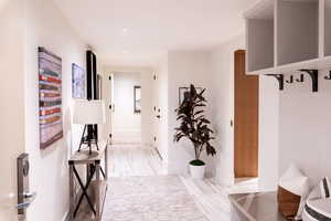 Hallway with baseboards and recessed lighting