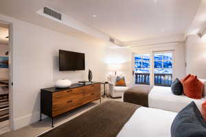 Carpeted bedroom featuring access to exterior and recessed lighting