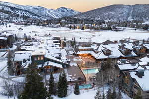 Snowy aerial view featuring a mountain view