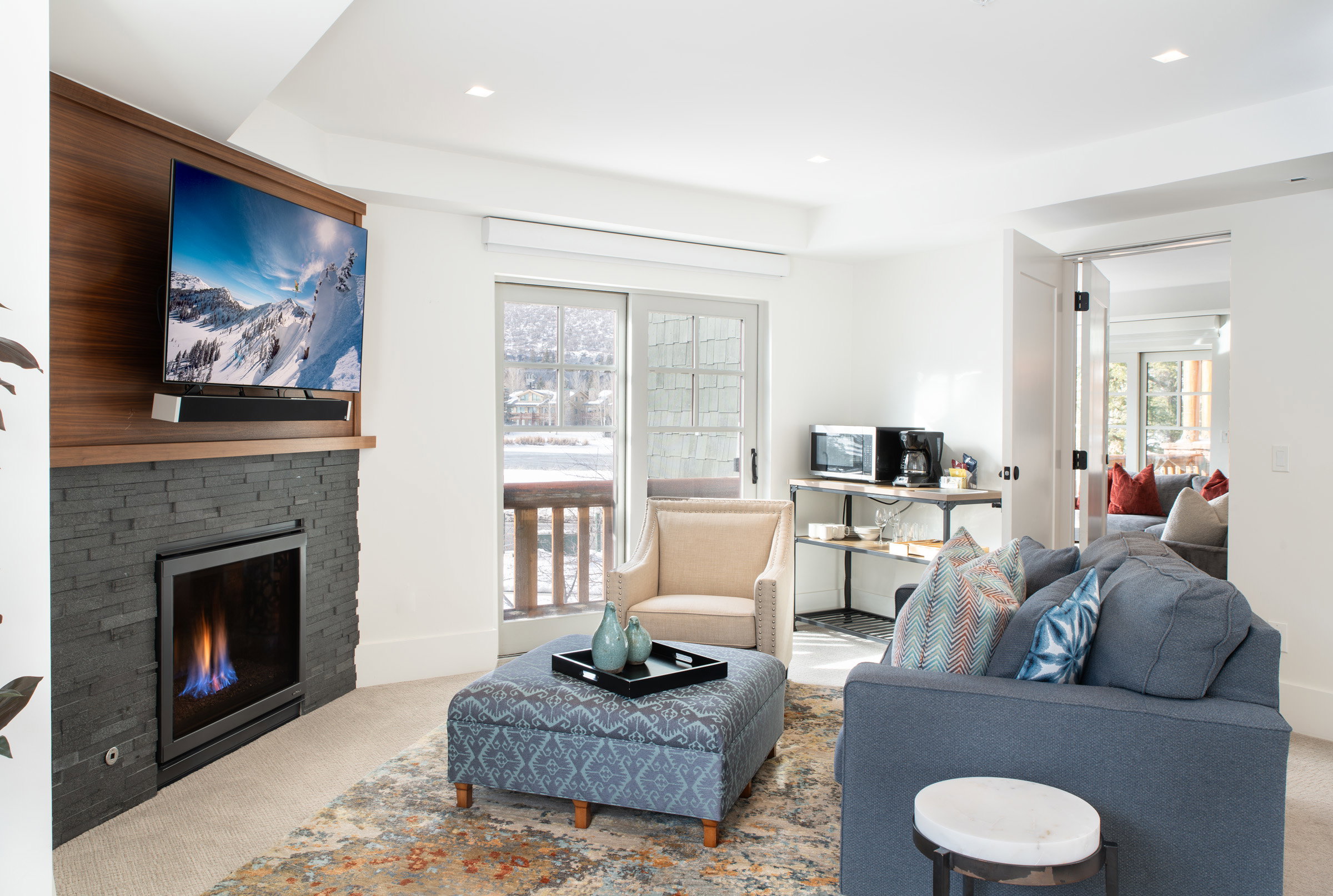 Living area featuring carpet flooring, a stone fireplace, plenty of natural light, and recessed lighting
