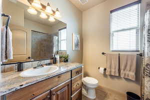 Bathroom with vanity, curtained shower, and light tile patterned flooring