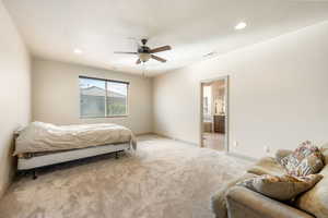 Bedroom with light carpet, recessed lighting, a ceiling fan, a textured ceiling, and connected bathroom