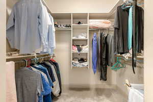 Walk in closet with light carpet