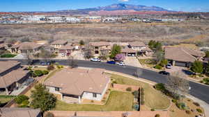 Aerial overview of property's location with nearby suburban area and a mountain backdrop