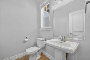 Half bathroom featuring baseboards and light wood-style flooring