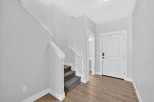 Entrance foyer with stairway and light wood-type flooring