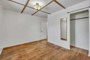 Unfurnished bedroom featuring light wood-style flooring and a closet