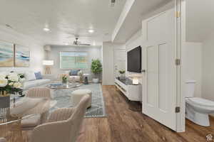 Living room with wood finished floors, a ceiling fan, a textured ceiling, and recessed lighting