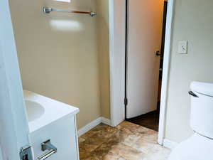 Bathroom featuring vanity and stone finish floors