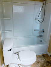 Bathroom with toilet and bathtub / shower combination