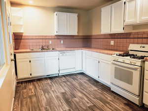 Kitchen featuring tile counters, white appliances, white cabinetry, and dark wood-style flooring