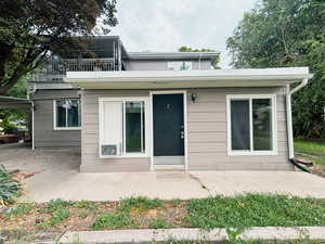 Doorway to property with a patio area