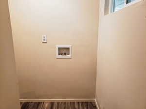 Laundry area with hookup for a washing machine and dark wood finished floors