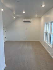 Bonus room featuring dark colored carpet, vaulted ceiling, and recessed lighting