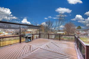 Deck with area for grilling and a residential view