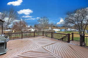 Deck featuring a residential view, area for grilling, and a yard