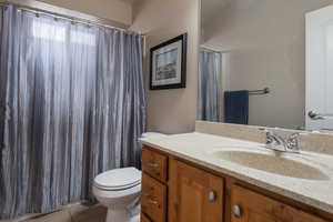 Bathroom with vanity, a shower with shower curtain, and light tile patterned floors