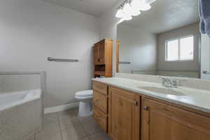 Full bathroom with a bath, vanity, and light tile patterned floors