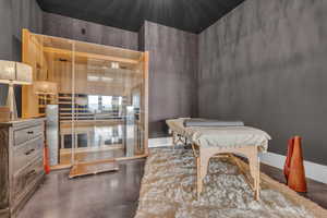 Dining room featuring a relaxing sauna and concrete floors