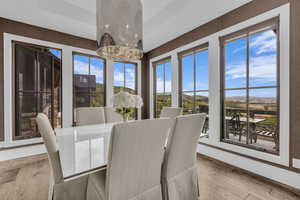 Dining space with a chandelier, light wood finished floors, and a mountain view