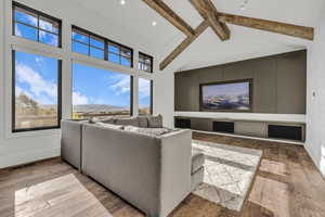 Living area with baseboards and light wood-style floors