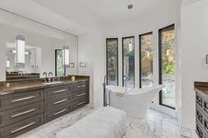 Bathroom with vanity and a soaking tub