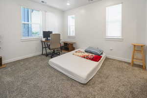 Bedroom featuring carpet, multiple windows, an office area, and recessed lighting