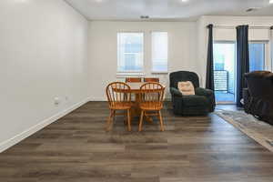 Dining room featuring dark wood-type flooring