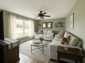 Living area with light wood-style flooring, ceiling fan, and plenty of natural light