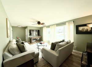 Living room featuring ceiling fan and wood finished floors
