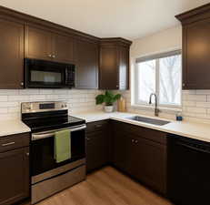 Kitchen featuring black appliances, dark wood finish cabinets, and decorative backsplash