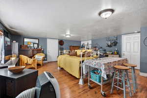Bedroom featuring hardwood / wood-style floors and a textured ceiling