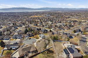 Aerial view of property's location with mountains and nearby suburban area