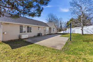 Back of house featuring a patio area, stucco siding, and a shingled roof