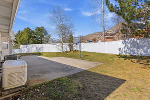 Fenced backyard featuring a patio