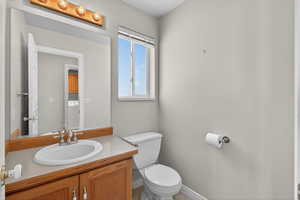 Half bath with vanity and washer / dryer off the garage entrance