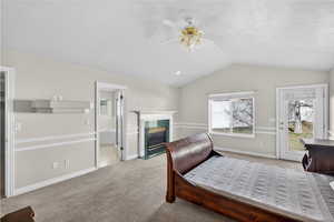 Master Bedroom featuring light colored carpet, a fireplace, access to outside, a ceiling fan, and a textured ceiling