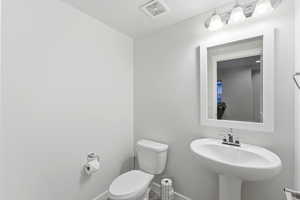Bathroom featuring toilet and baseboards