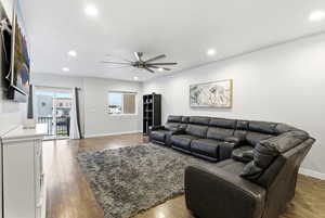 Living room featuring hardwood / wood-style floors, ceiling fan, and recessed lighting