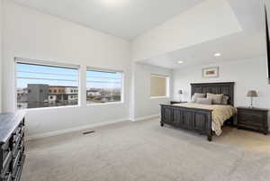 Bedroom featuring light carpet and recessed lighting