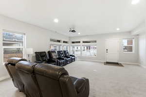 Cinema room featuring light colored carpet, healthy amount of natural light, and recessed lighting