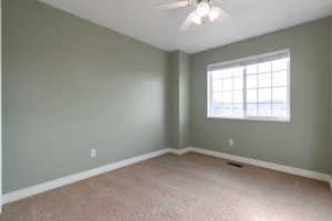 Bedroom featuring ceiling fan and light colored carpet