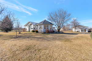 View of back of home at sunroom area