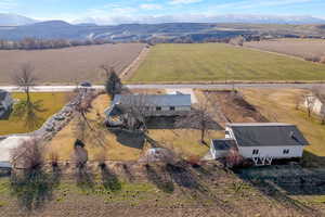Aerial view of home with large workshop/secondary garage and garden room as well as garden area.