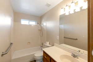 Full bath featuring vanity and shower/tub combination