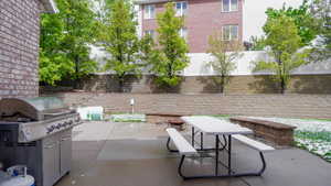 Fenced backyard with a patio and a grill